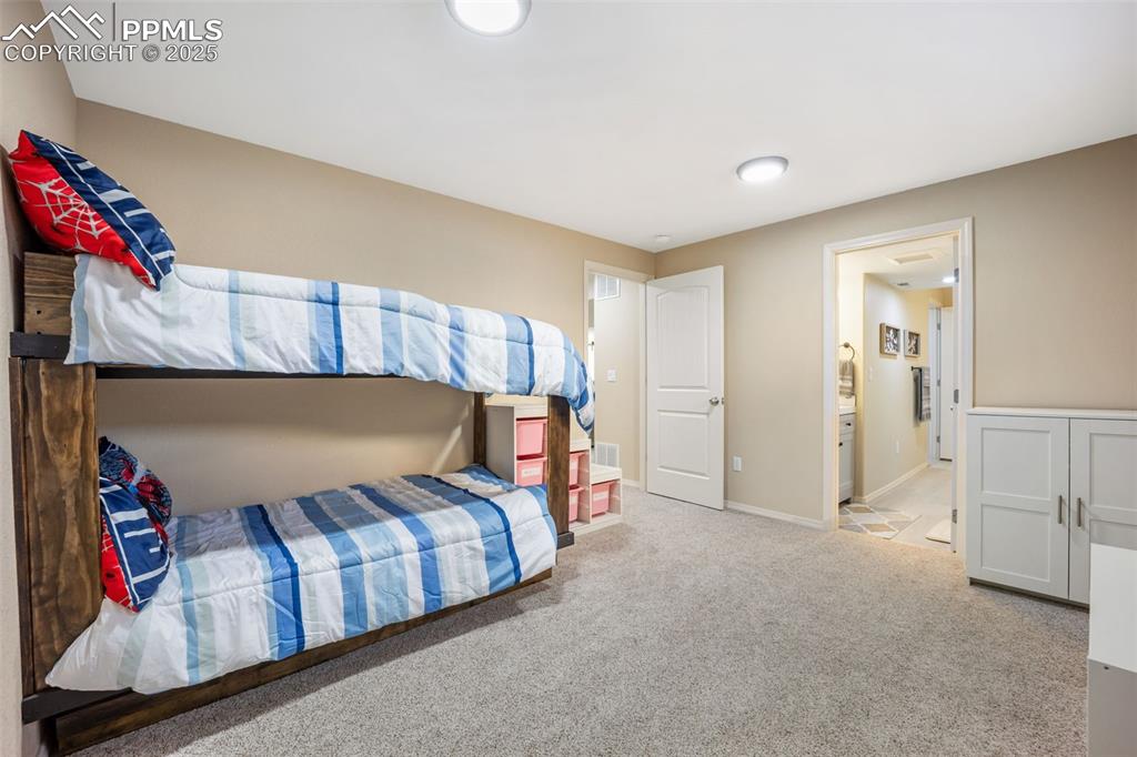 Image 39 of 50: Bedroom featuring light carpet and baseboards