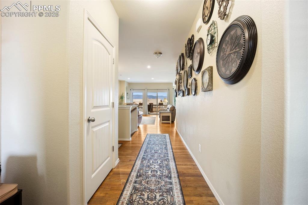 Image 4 of 50: Hallway featuring wood finished floors