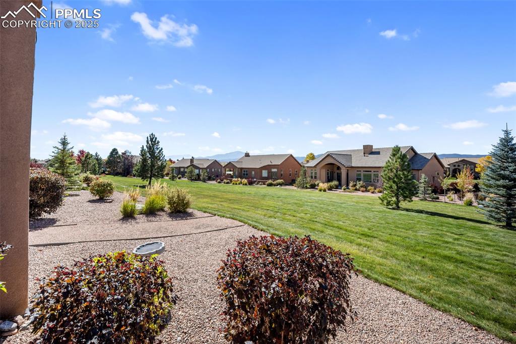 Image 41 of 50: View of green lawn with a residential view