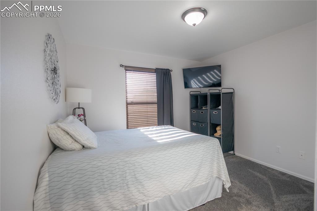 Image 12 of 34: Kitchen featuring arched walkways, white cabinetry, a peninsula, a ceiling