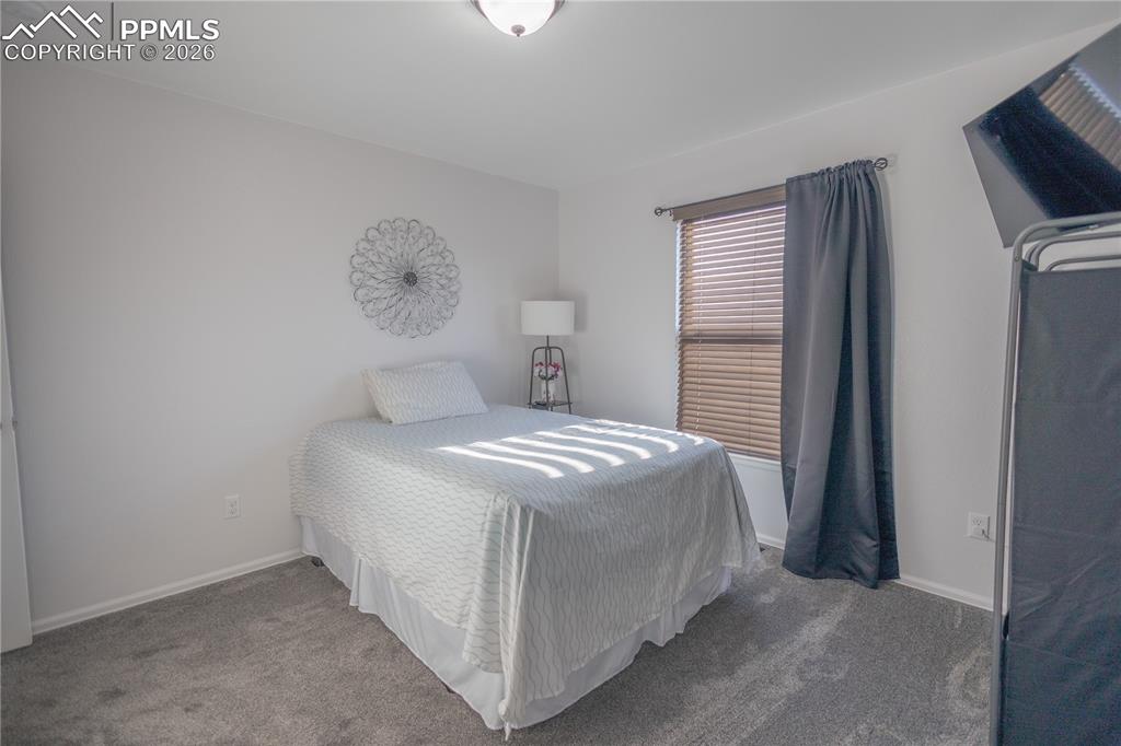 Image 2 of 34: Ranch-style house featuring stucco siding, an attached garage, and covered