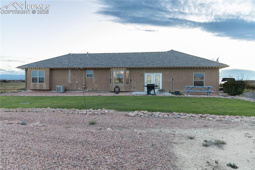 Image 33 of 34: Rear view of property featuring a patio area, stucco siding, a shingled roo