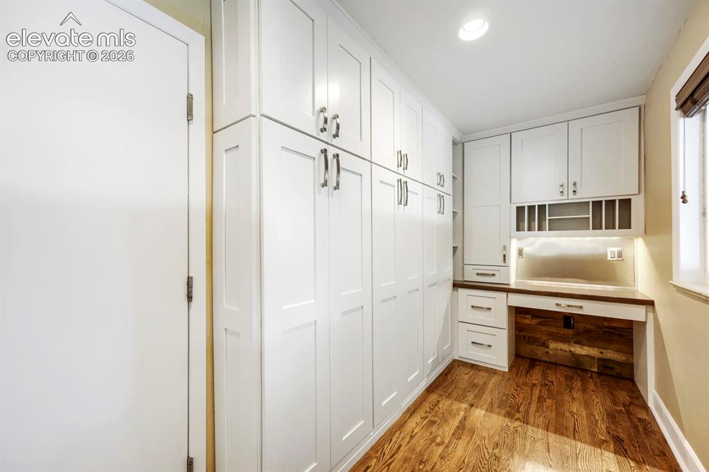 Image 14 of 41: Office niche with wall of pantry cabintry!