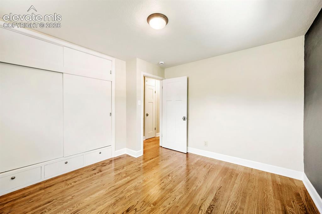 Image 17 of 41: Gleaming hardwoods in this secondary main level bedroom!