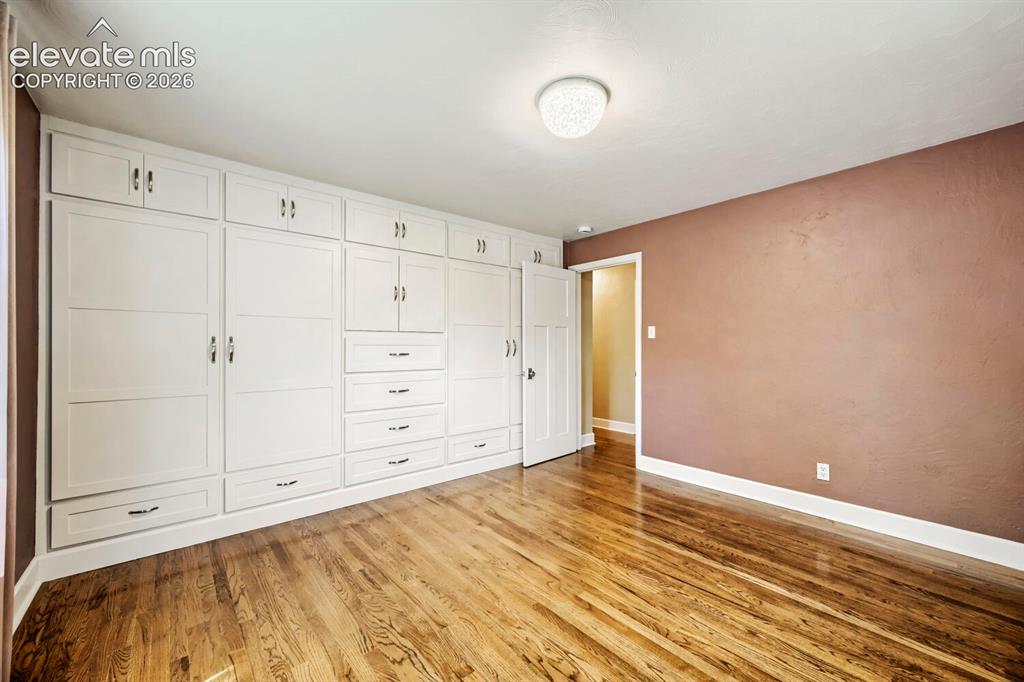 Image 20 of 41: View to wall of custom wardrobe cabinetry!