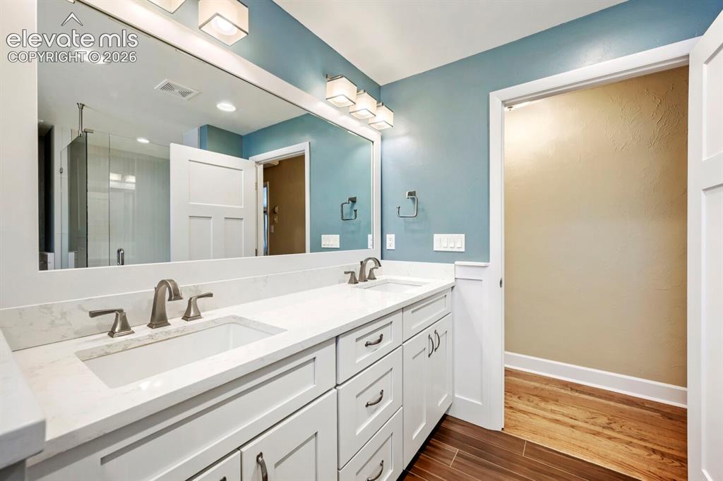 Image 22 of 41: Primary fully remodeled bathroom with quartz and double sinks!
