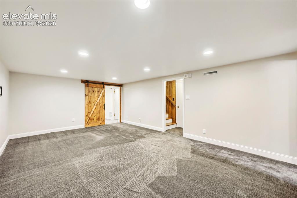 Image 25 of 41: Large family room, well insulated and ready for TV nights and play!