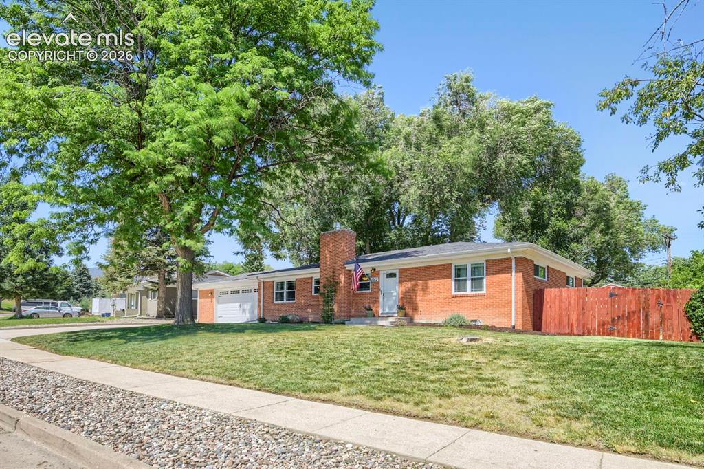 Image 5 of 41: View from street to front and side of the home that has the swing gate a sp