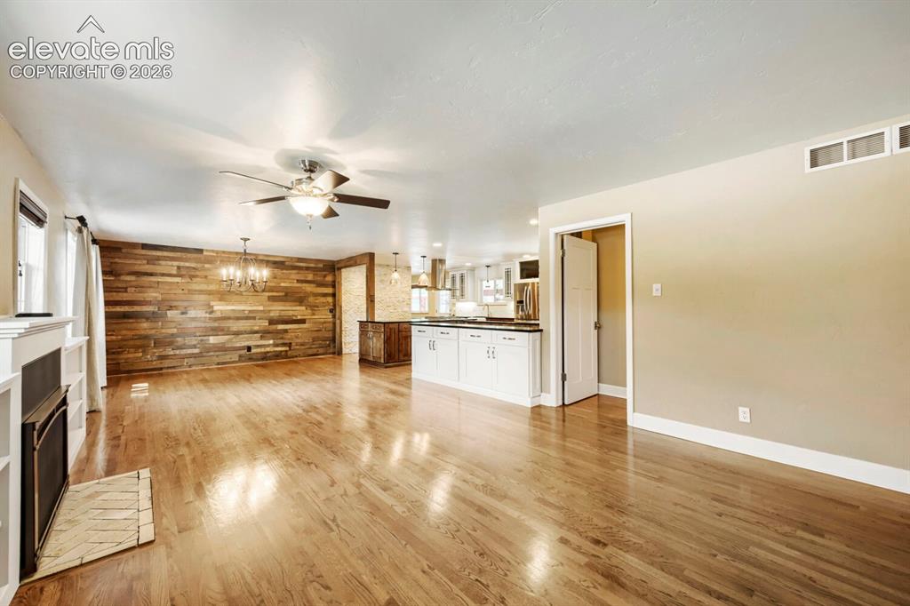 Image 6 of 41: Expansive gleaming hardwoods and new gas fireplace that has a battery backu