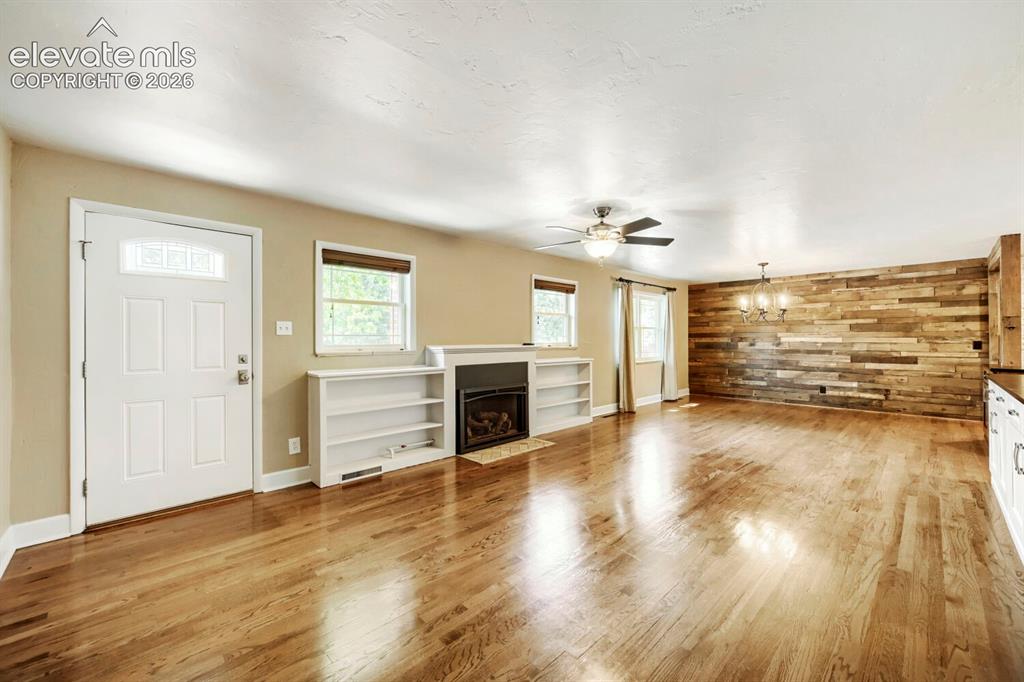 Image 7 of 41: Expansive wood floorings, newer windows , newer gas fireplace with battery