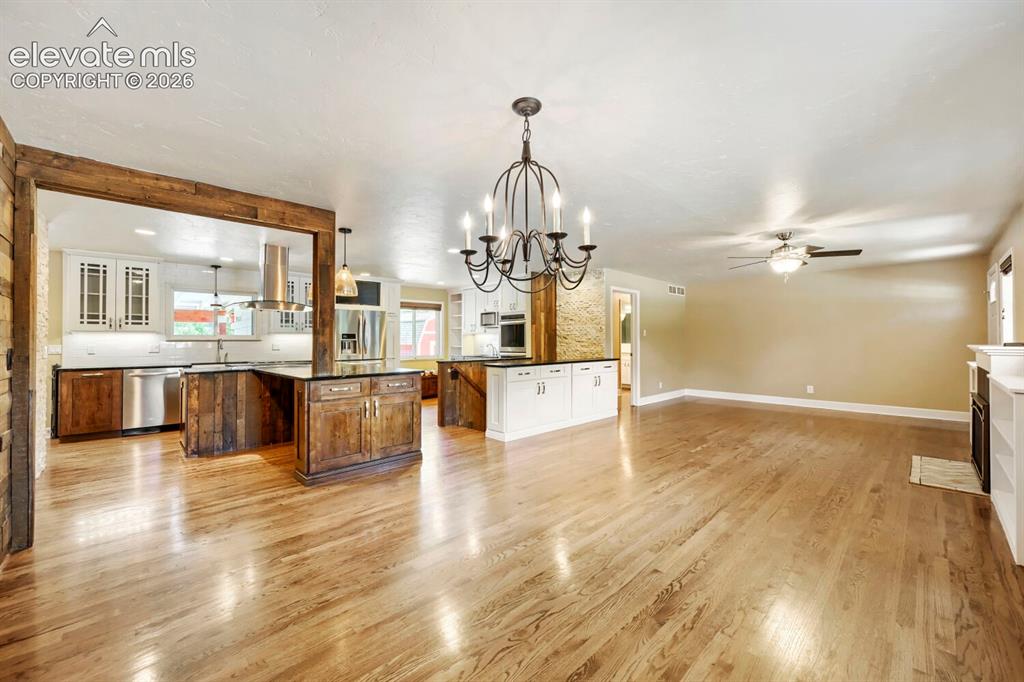 Image 9 of 41: View from Dining room to the living room & custom gourmet kitchen!
