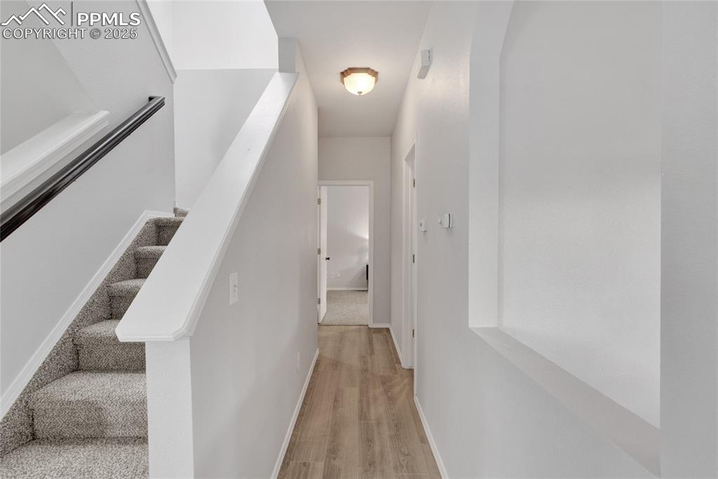 Image 13 of 44: Stairs featuring wood finished floors and baseboards