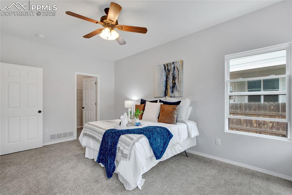 Image 15 of 44: Carpeted bedroom with baseboards and a ceiling fan