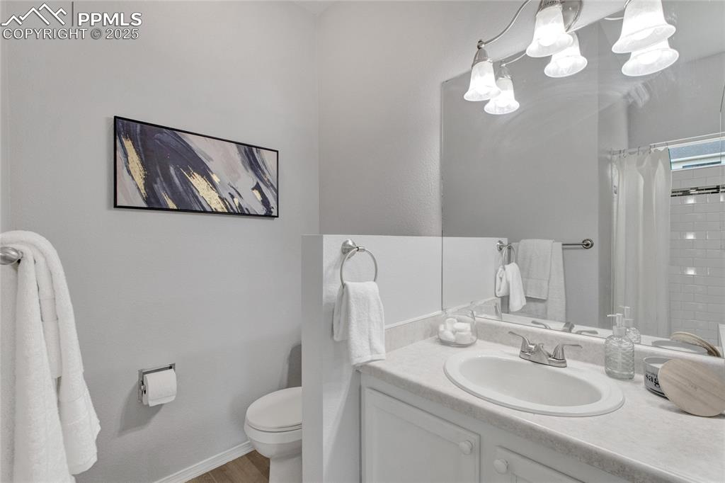 Image 17 of 44: Bathroom featuring vanity, a shower with curtain, and wood finished floors