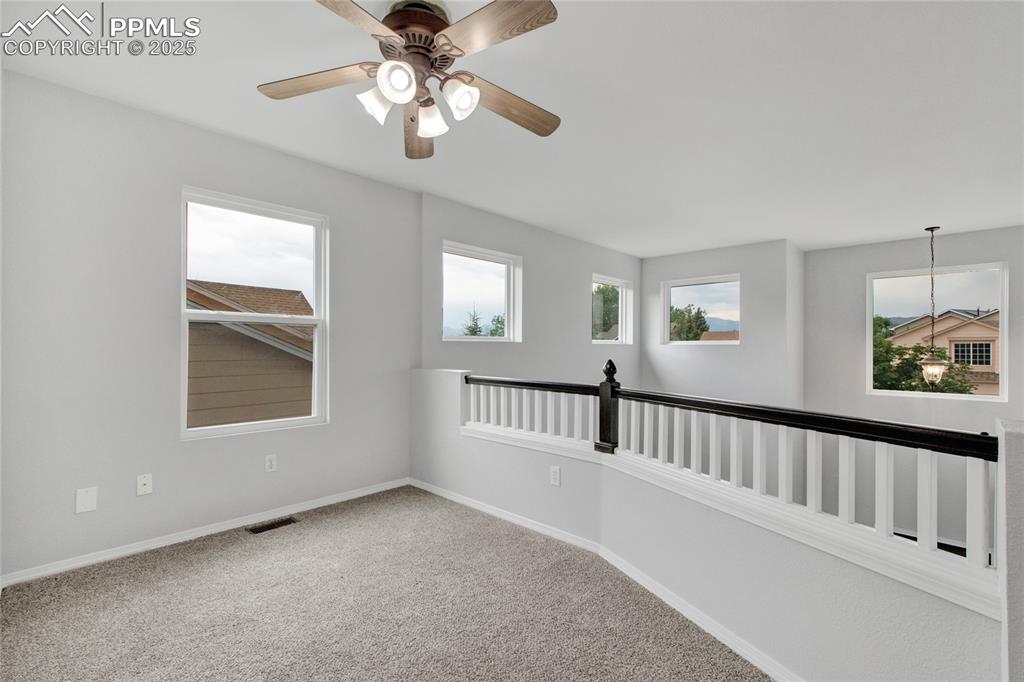 Image 20 of 44: Carpeted empty room featuring baseboards and a ceiling fan