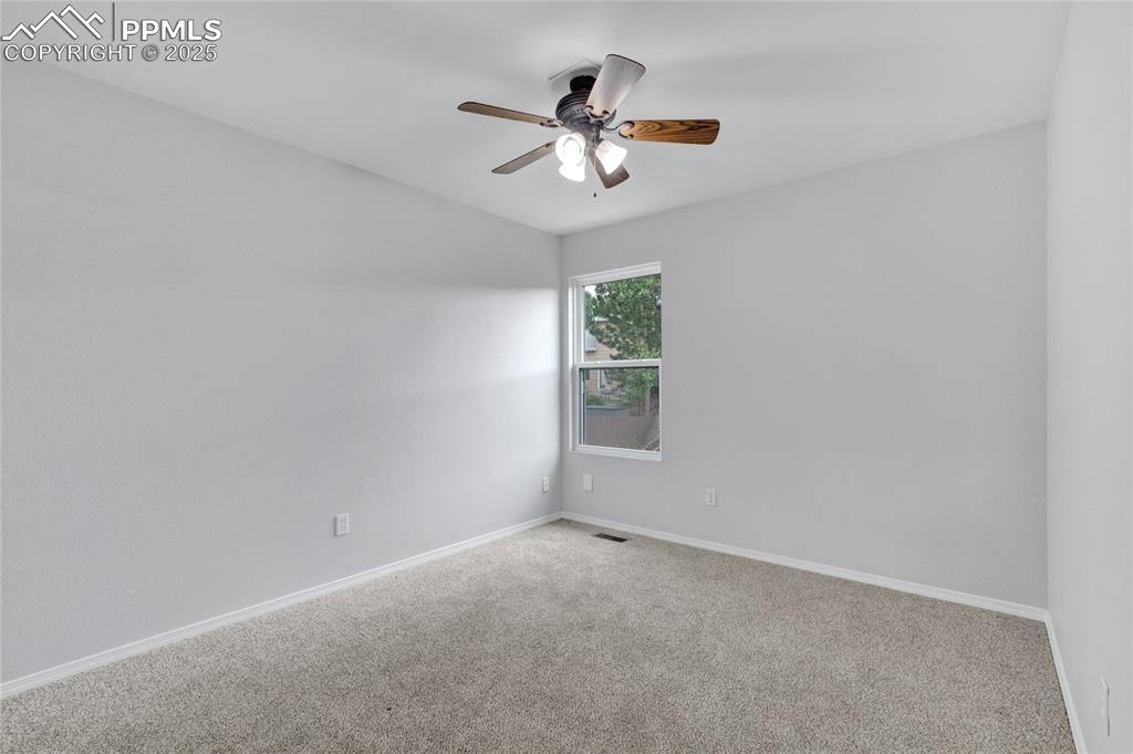 Image 22 of 44: Carpeted empty room featuring ceiling fan and baseboards