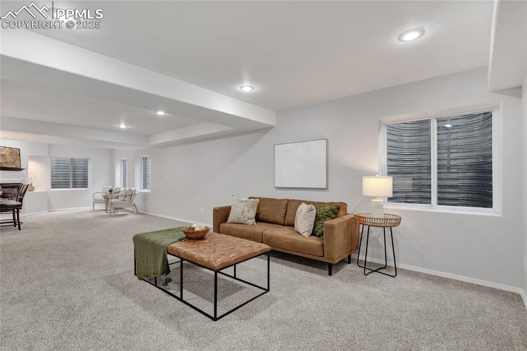 Image 28 of 44: Living area featuring light carpet and recessed lighting