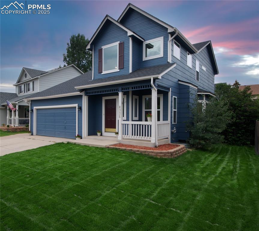Image 3 of 44: View of front of property with covered porch, a yard, and driveway