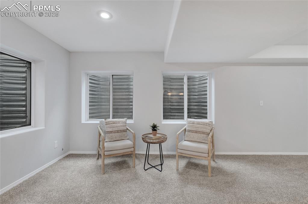 Image 32 of 44: Sitting room with carpet and baseboards