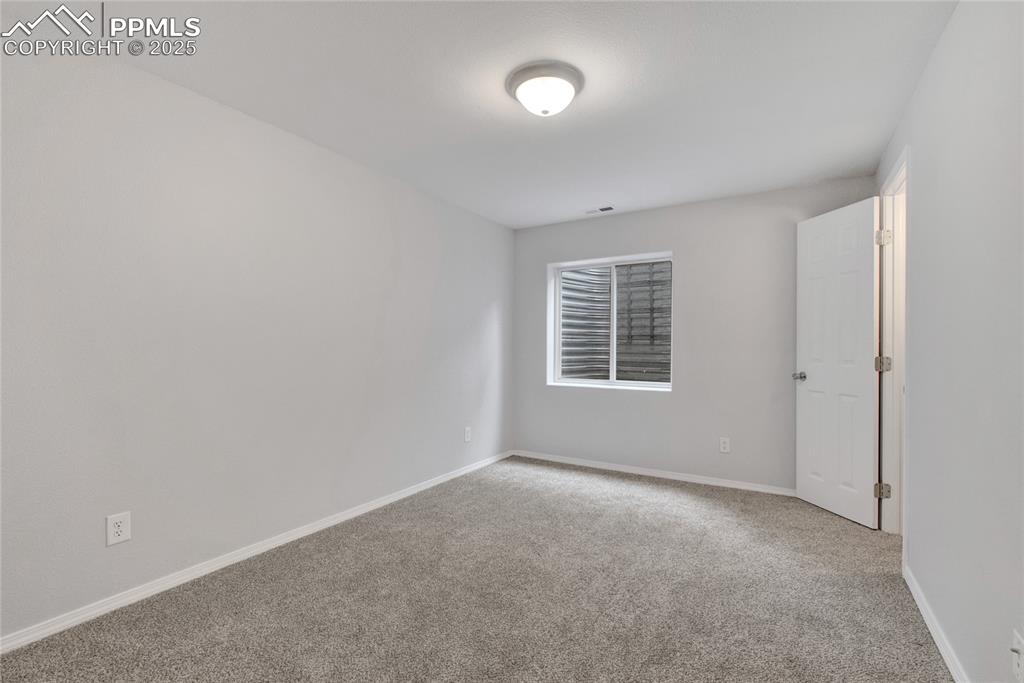 Image 33 of 44: Unfurnished room featuring carpet