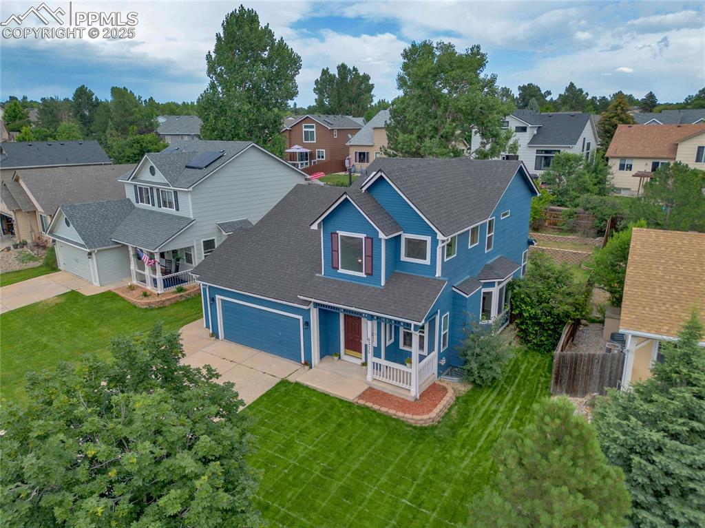 Image 42 of 44: View of front of home with concrete driveway, a porch, a residential view, 