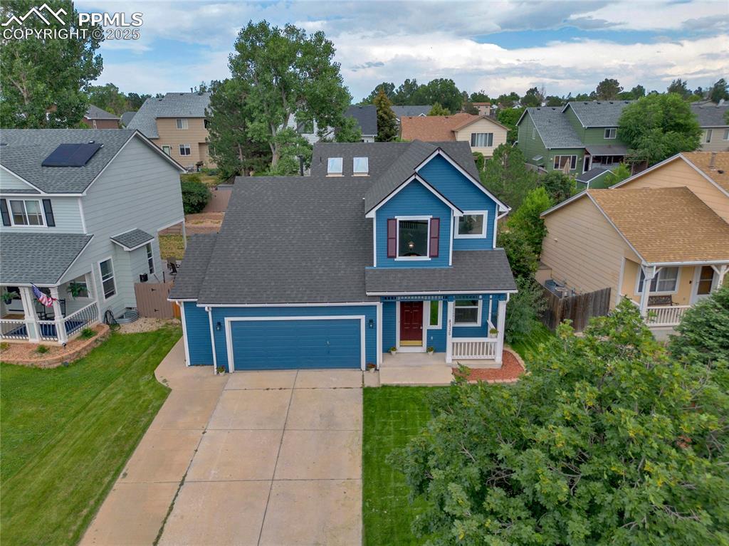 Image 43 of 44: Traditional home with a residential view, driveway, an attached garage, a s