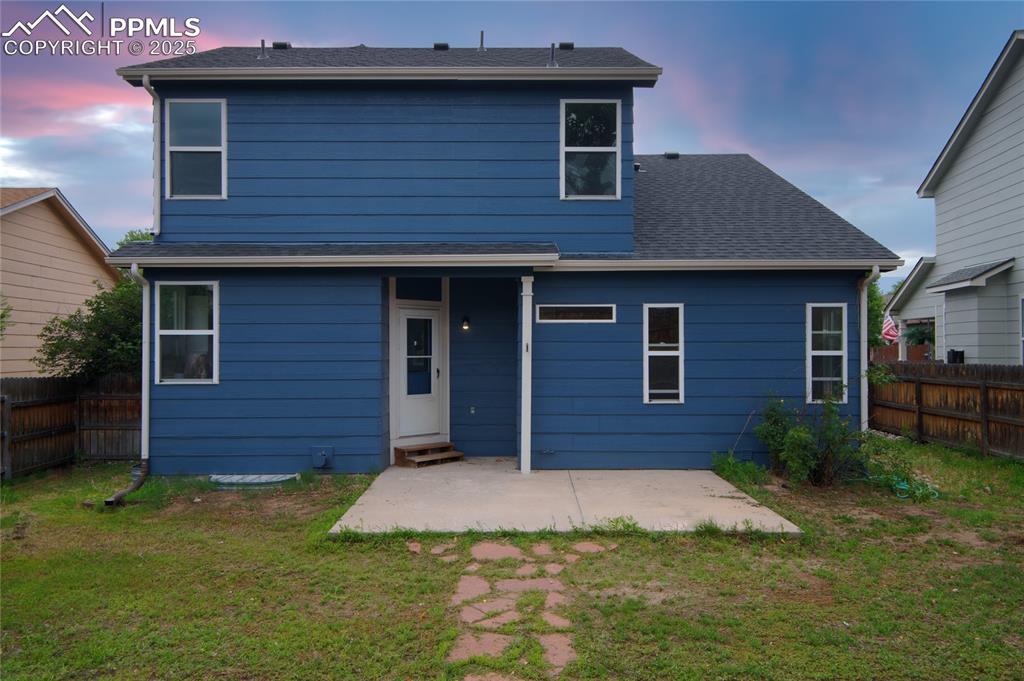 Image 5 of 44: Back of property at dusk featuring a patio area and entry steps