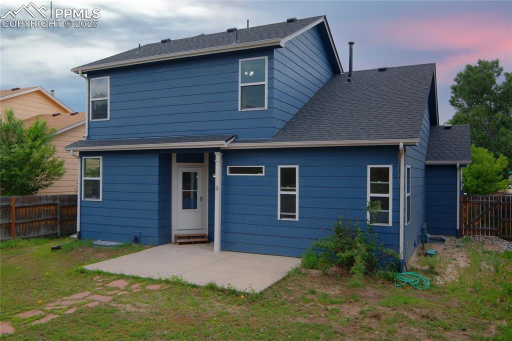 Image 6 of 44: Rear view of property with a patio and roof with shingles