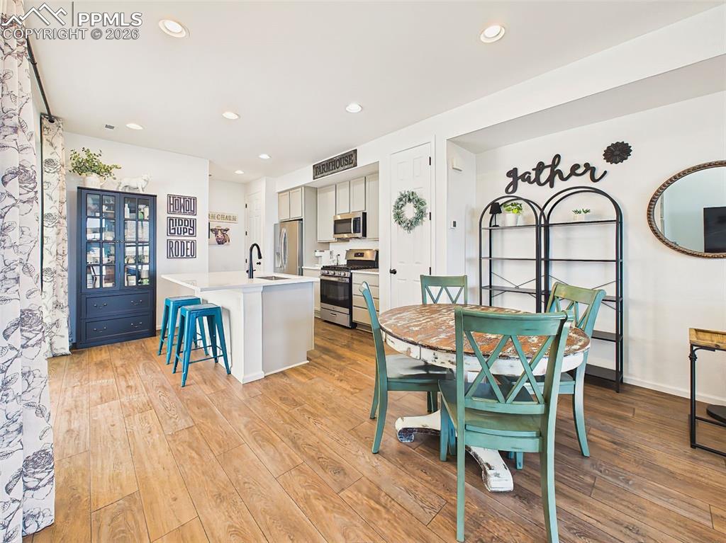 Image 11 of 50: Dining Area – Bright dining space with durable wood-look flooring and seaml
