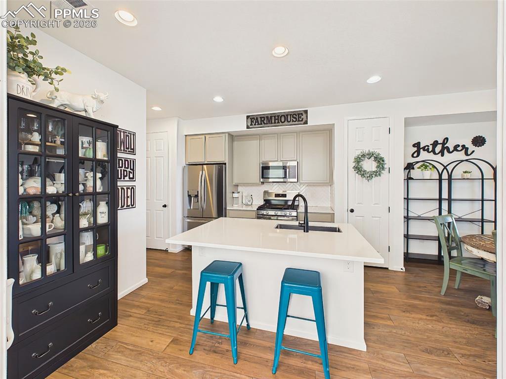 Image 13 of 50: Kitchen – Stylish kitchen featuring quartz countertops, stainless steel app