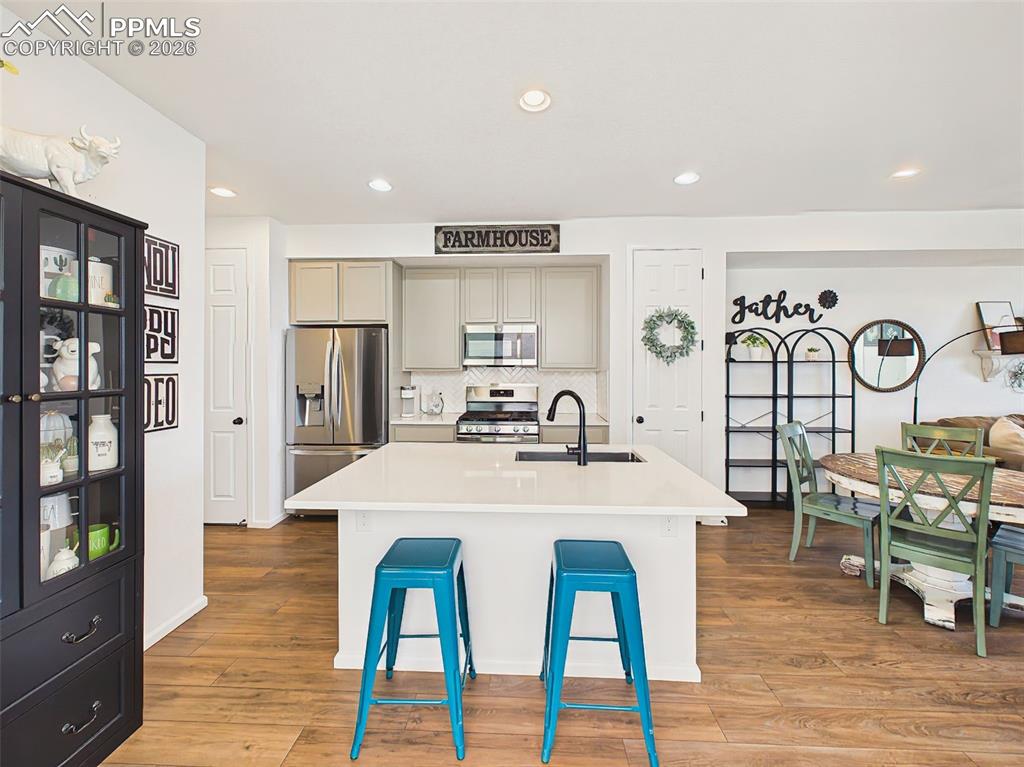 Image 16 of 50: Kitchen / Dining – Open-concept kitchen with expansive island seating and s