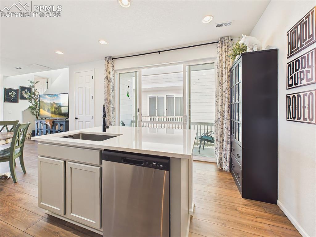 Image 18 of 50: Kitchen Detail – Large center island with undermount sink, dishwasher, and 