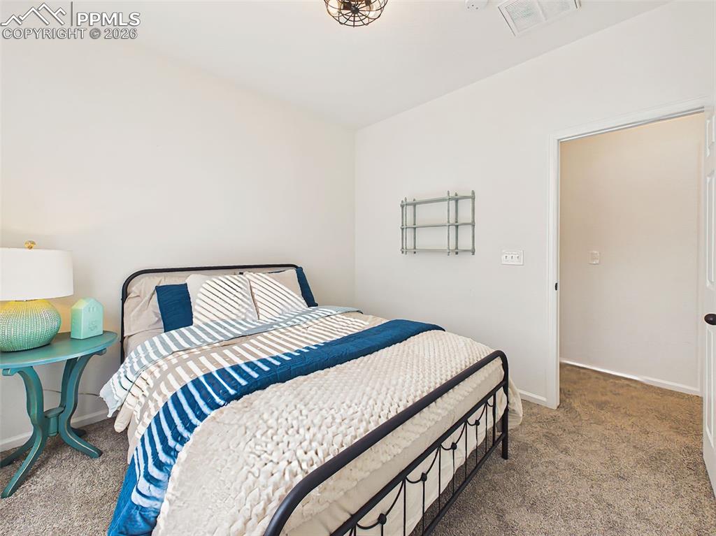 Image 29 of 50: Secondary Bedroom – Well-sized secondary bedroom with plush carpeting and c