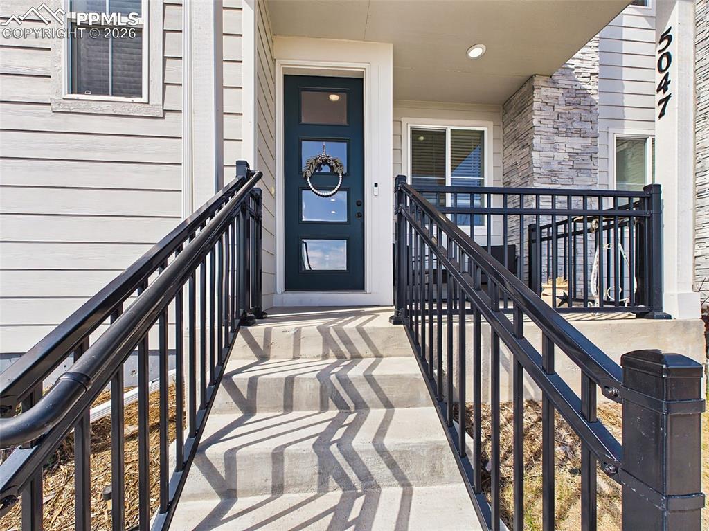 Image 3 of 50: Exterior – Covered front porch with mountain-view setting and space for out