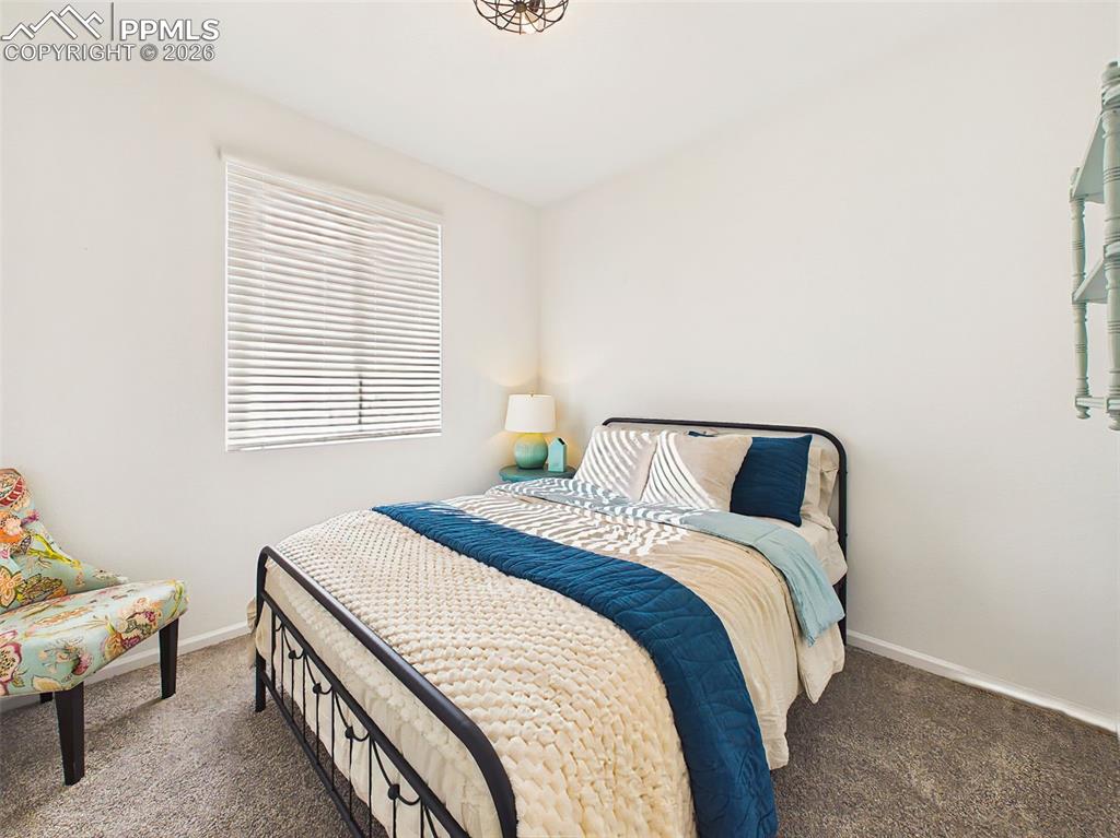 Image 30 of 50: Secondary Bedroom – Comfortable guest bedroom with soft natural light and n