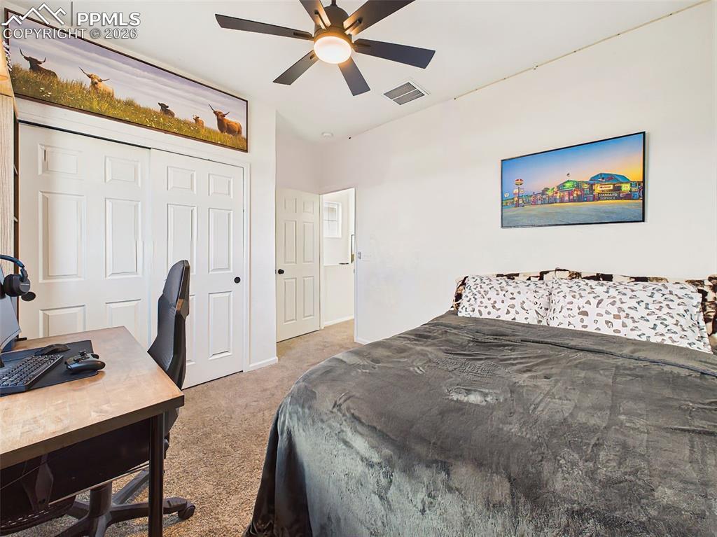 Image 32 of 50: Third Bedroom – Bright secondary bedroom featuring large window, built-in w