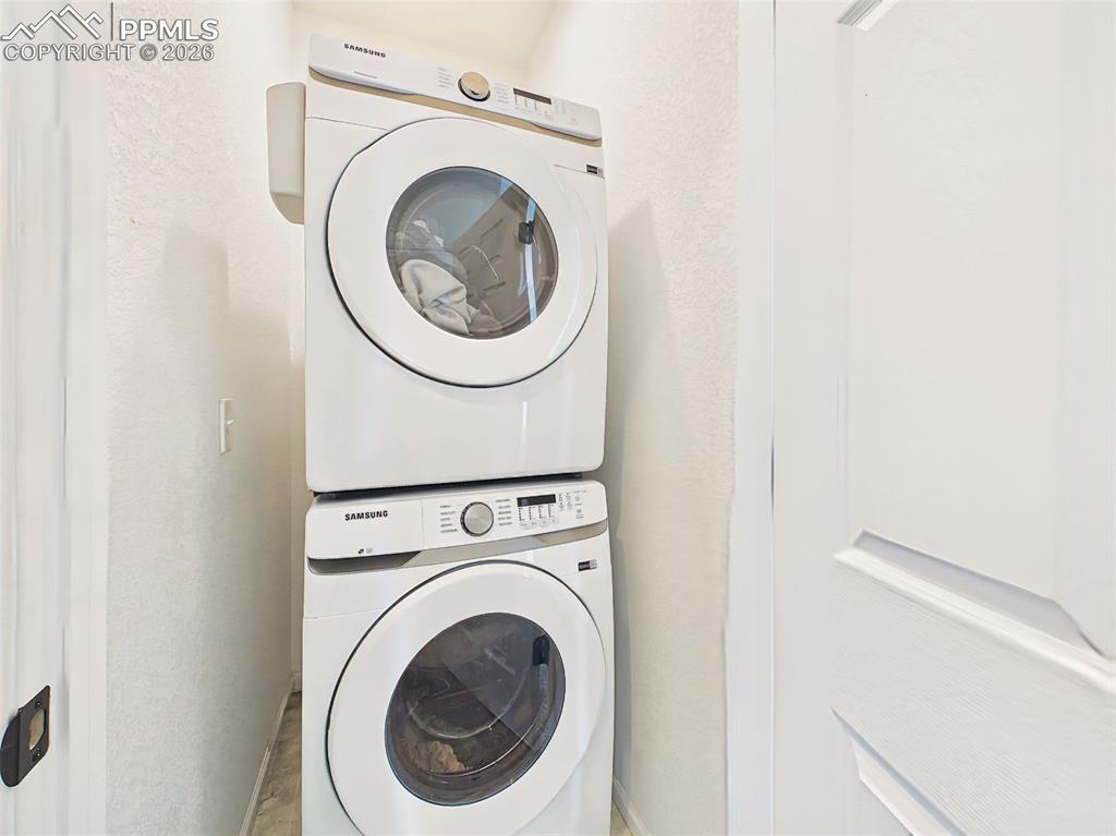 Image 34 of 50: Laundry Closet – Convenient in-unit laundry area with stacked washer and dr