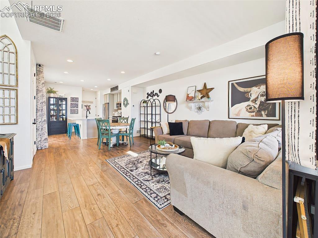 Image 6 of 50: Living Room – Generous open living space with seamless flow into dining and