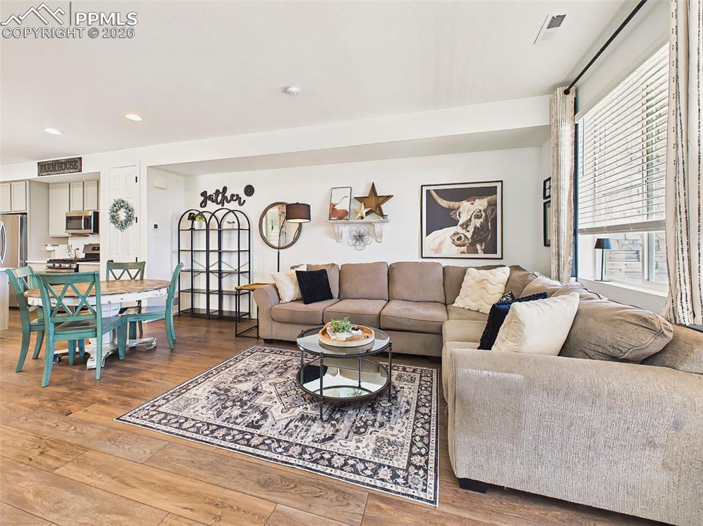 Image 7 of 50: Living Room – Comfortable gathering space featuring abundant natural light 