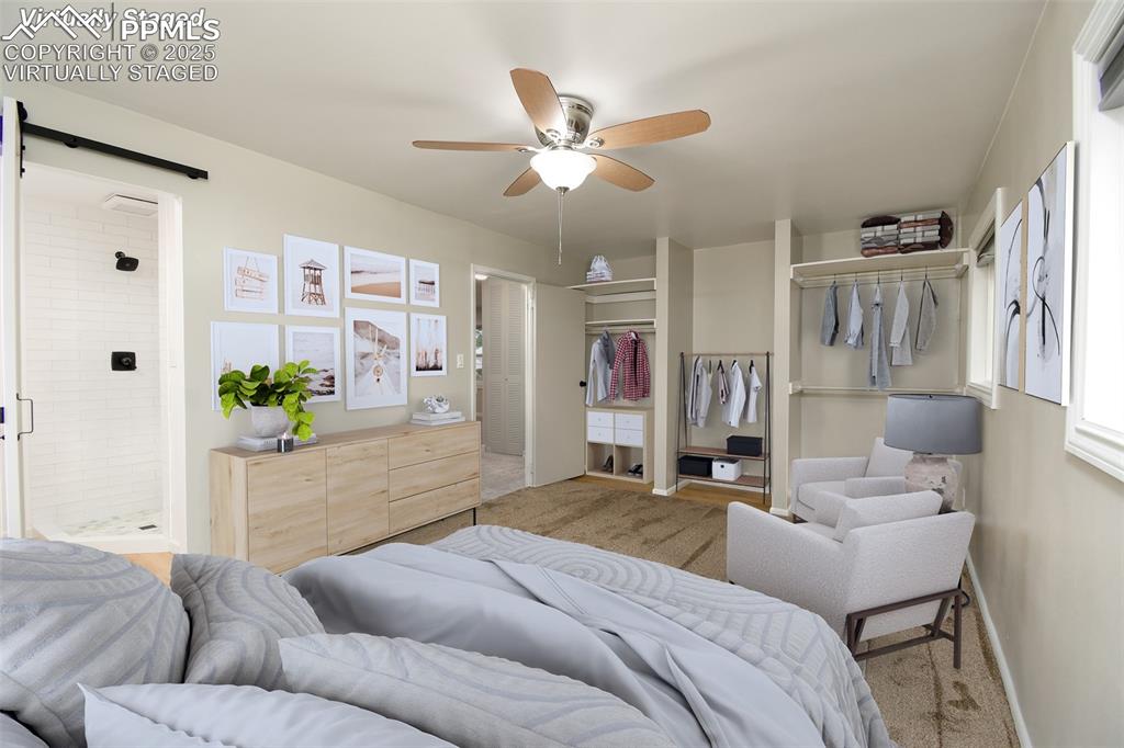 Image 12 of 25: Virtually Staged Carpeted bedroom featuring a barn door, a closet, and ceil