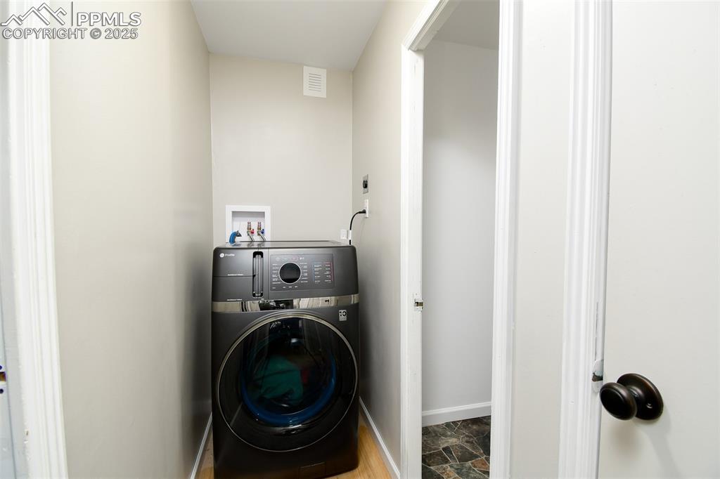 Image 18 of 25: Washroom with washer / dryer and baseboards