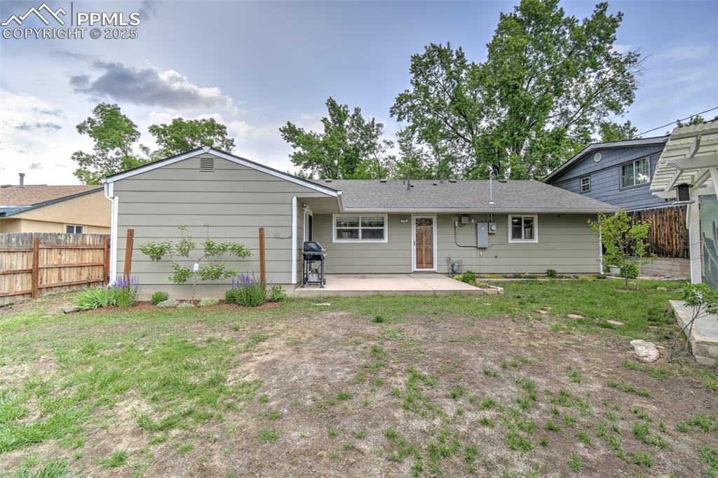 Image 22 of 25: Rear view of property featuring a patio and roof with shingles