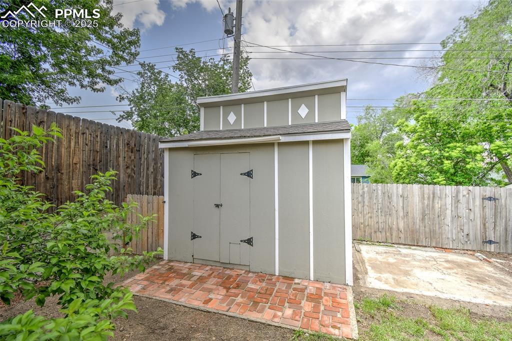 Image 25 of 25: View of shed featuring a fenced backyard