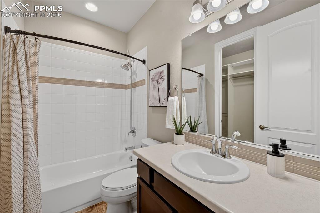 Image 18 of 34: Bathroom featuring vanity and shower / tub combo with curtain