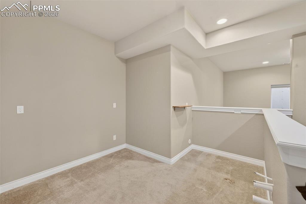 Image 27 of 34: Walk in closet with light colored carpet