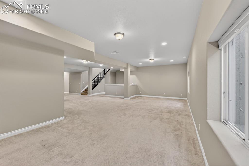Image 28 of 34: Finished below grade area featuring light carpet and recessed lighting