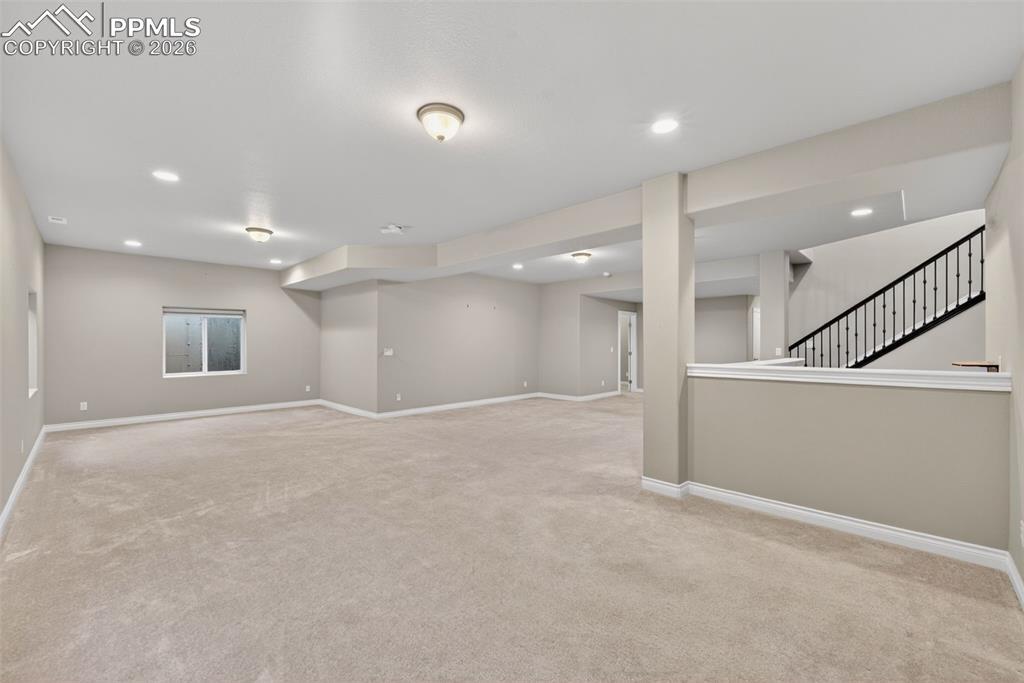 Image 29 of 34: Finished below grade area featuring light carpet and recessed lighting