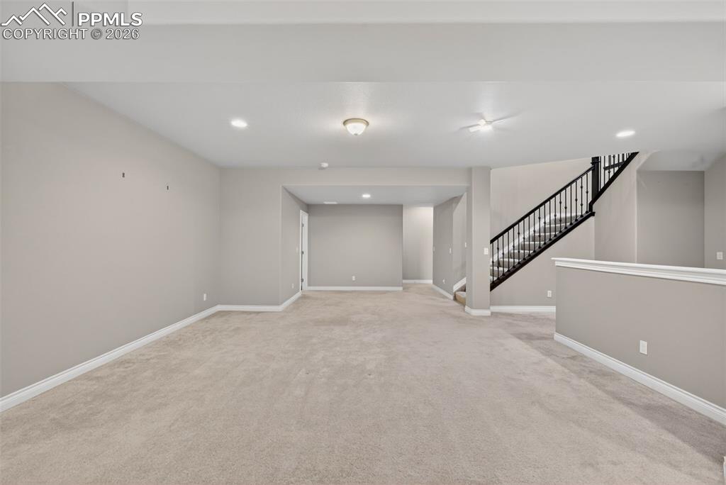Image 30 of 34: Finished below grade area featuring light colored carpet and recessed light