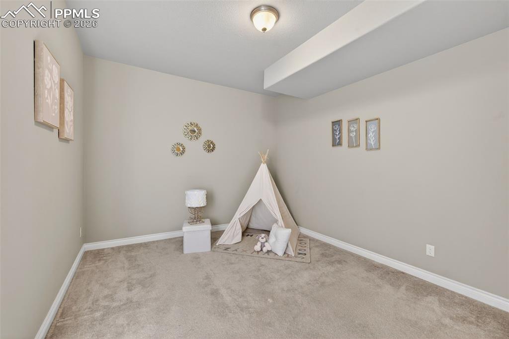 Image 32 of 34: Finished below grade area featuring light carpet and recessed lighting