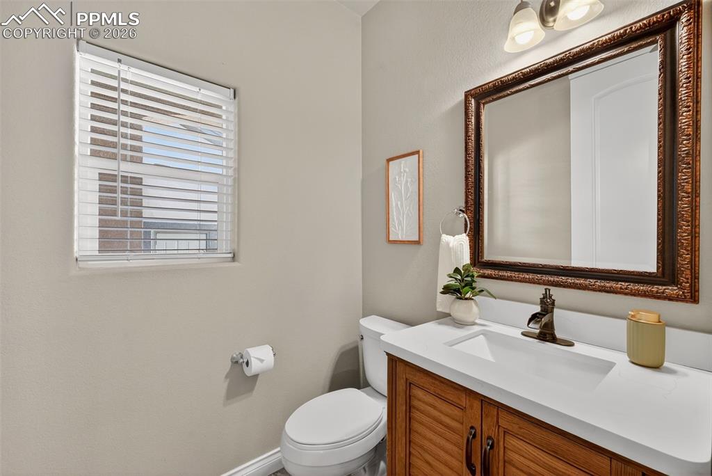 Image 8 of 34: Half bathroom with vanity and toilet